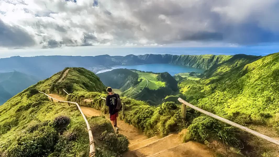 Hiking trail in the Azores, Portugal, overlooking a crater lake and mountains