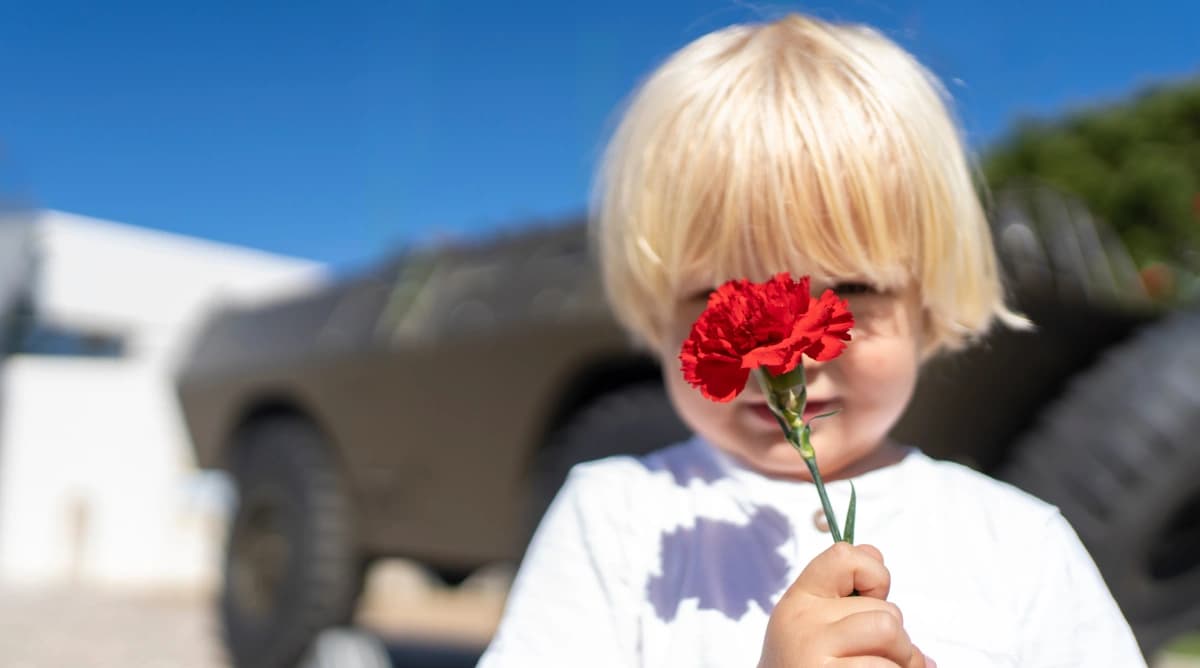 Kid Holding a Red Carnation During the Celebrations of 25th of April, Freedom Day in Portugal.