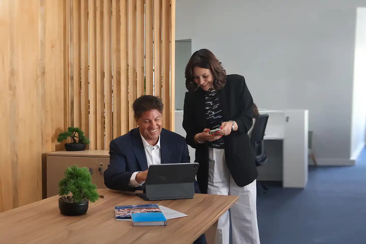 Two advisors assisting a client at Portugal Homes' Lisbon branch.